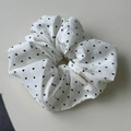 Détail d'un chouchou blanc avec motifs de cœurs noirs et étiquette de marque - Chouchou Blanc Cassé