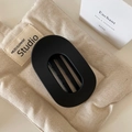 Detail view of a black matte oval hair claw clip with internal teeth for strong grip - Matte Black