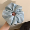 Close-up of a large light blue satin scrunchie showing the soft pleated silk texture - Large / Blue