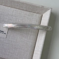 Macro shot of iridescent acetate barrette hair clip with Barrette La France lettering - Clear White