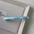 Close-up of blue and white marble acetate hair clip with Barrette La France gold lettering - Blue