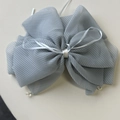 Close-up of elegant plaid fabric bow hair claw with sparkling crystal bead accents - Blue