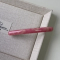 Detail of pink marble acetate hair clip with golden Barrette in France text - Pink