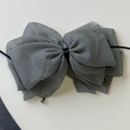 Detail of gingham tulle bow hair clip with crystal bead trim and central black satin knot - Black