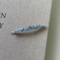Close-up of blue marbled acetate spindle hair clip with France Handmade engraving - Ink Wash Blue