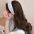 Close-up of light blue knitted headband with metallic heart detail and soft texture - Blue