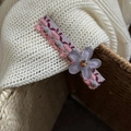Nahaufnahme der rosa floralen Haarspange mit lila Blume und funkelndem Edelstein - Lila Blume