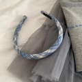 Detailed close-up of blue plaid fabric headband with elegant internal brand label - Light Blue