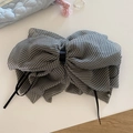 Detalle de un lazo grande a cuadros blancos y negros para el pelo con cintas de seda negras - Negro
