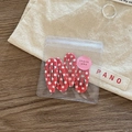 Detailed view of four red polka dot BB hair clips in a small transparent zipper pouch - Red Polka Dot