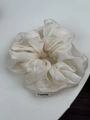 Detailed close-up of large off-white organza scrunchie with layered pleats and woven tag - Off-white