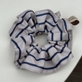 Detail of light grey fabric scrunchie with blue stripes and Forever logo tag - Blue Striped Scrunchie