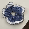 Detailed macro view of French blue plaid scrunchie with lace trim and bow knot - Stripe Style
