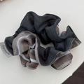 Detail of ruffled scrunchie featuring mixed fabric textures and a numbered woven label - Dark Gray Patchwork Stripes