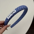 Détail d'un serre-tête rembourré à carreaux bleus avec écusson brodé 'hello' et sourires - Serre-tête Plaid Bleu