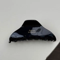 Detail view of glossy black hair claw clip with golden Barrette la France text - Black