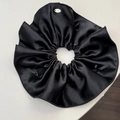 Detail of black satin hair scrunchie with silk ribbon bows and silver Lucky metal tag - Black