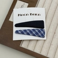 Close-up of a blue plaid and black fabric BB hair clip set on a luxury jewelry display tray - Triangle Hair Clips