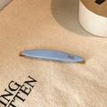 Detail of light blue acetate hair clip with golden Creation France lettering on canvas - Blue