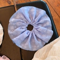 Detailed texture of lavender seersucker scrunchie with subtle floral pattern - Blue