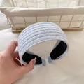 Dettaglio fascia larga azzurra con trama a costine verticali in maglia e finitura in tessuto - Zircone Blu Chiaro