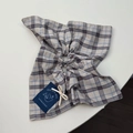 Close-up of blue striped scrunchie fabric featuring a cute bear woven label and text - Khaki Striped Bear