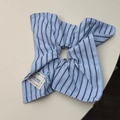Close-up of blue striped scrunchie with a hand-made label and blue bow detail - Blue Striped