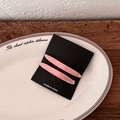 Detail of pink acetate hair clips with gold Barrette La France lettering on a black card - Pink