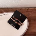 Detail view of two tortoiseshell acetate barrettes on display card and ceramic plate - Light Tortoiseshell