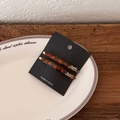 Elegant tortoise shell pattern acetate hair clip set on minimalist white ceramic plate - Blue Brown Gradient