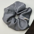 Close-up of dark grey pleated scrunchie with silk sheen and Hand Made textile label - Grey Scrunchie