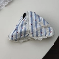 Detail of blue striped fabric scrunchie with red heart prints and white lace edge - Blue Stripe Claw Clip