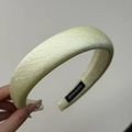 Detail of pistachio green textured fabric headband with handmade label and thick padding - Yellow Headband