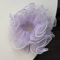 Detail of light purple mesh scrunchie featuring white polka dots and ruffled edges texture - Purple