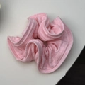 Close-up of pink striped knit scrunchie texture with elastic frill details - Pink