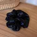 Detailed close-up of a large black satin scrunchie with a Fashion woven label - Black