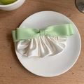 Detailed view of light green ribbon bow and milky white pleated satin hair clip - Green
