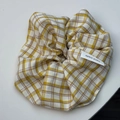 Detail of yellow checkered scrunchie with handmade tag showing fabric texture - Cotton Linen / Dark Yellow Plaid Scrunchie