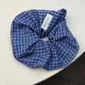 Detail of blue and white checkered fabric scrunchie with a sewn handmade label - Dark Blue Plaid (Scrunchie)