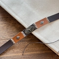 Detailed macro view of stitched leather belt with vintage bull head metal buckle design - Bull Head Metal Buckle Leather Belt Style (D)