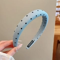 Close-up of light blue polka dot headband with ribbed fabric and handmade label - Polka Dot Style