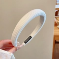 Detail showing the white ribbed fabric headband with an interior Hand Made woven label - Cream Ribbed Style