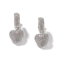 Close-up of hip-hop pavé heart earrings featuring white cubic zirconia on silver setting - Silver
