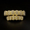 Detail shot of gold-plated hip hop teeth grills with iced out rhinestones on black background - Gold Set (Square and Round Diamonds)