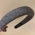 Dettaglio di un cerchietto in feltro di lana grigio con texture e etichetta fatta a mano - Grigio