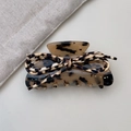 Close-up of leopard print bow hair claw clip with elegant tortoiseshell pattern - Light Leopard
