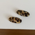 Detail of two oval leopard print hair clips with a glossy finish for vintage styling - Oval Clip / Yellow Stripes