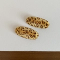 Close-up of two leopard print oval hair clips with polished vintage resin finish - Oval Clip / Yellow Leopard