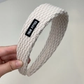 Primer plano de diadema de punto crema con tejido texturizado y etiqueta TRUE FITTED - Blanco Roto