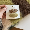Detail view of two oval clips in colorful tweed and olive green boucle wool fabric - Yellow-Green